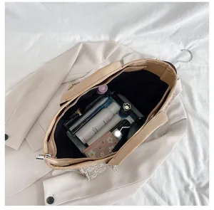 Top-down view of a spacious beige tote bag interior showing various daily essentials