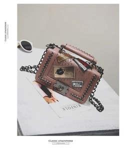 Pink crossbody box bag with metal studs, chain edges and vintage embroidered patches