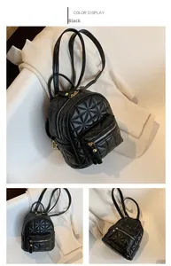 Detail of black mini backpack with star pattern quilting and golden zippers
