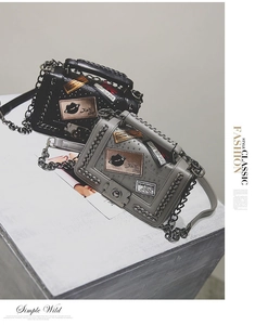 Close-up of stylish chain shoulder bags with metallic rivets and fashion patch details