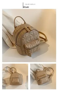 Detail view of khaki mini backpack featuring quilted triangle patterns and gold zippers