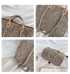 Detail of tweed tote bag showing leather handles and metal chain shoulder strap texture