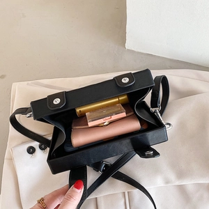 Top-down view showing the compact interior storage of this black leather box bag