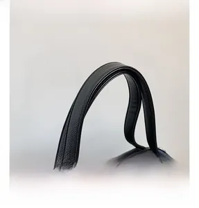 Close-up of black lychee grain leather tote bag with reinforced double stitching handles