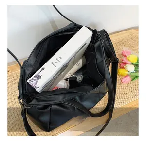 Detailed interior of black pebbled leather tote bag showing large storage capacity