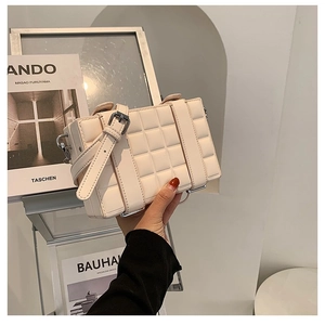 Quilted cream box shoulder bag with adjustable leather strap and silver hardware