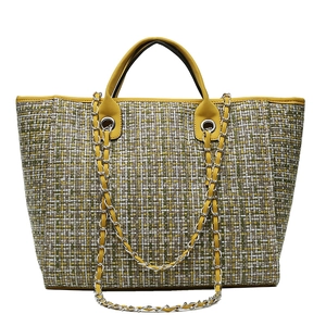 Plaid tweed bucket bag with yellow leather handles and silver chain shoulder strap