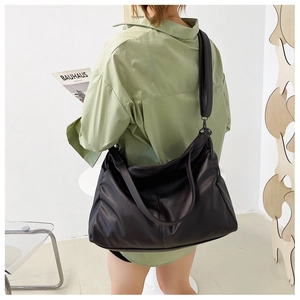 Model view of large black PU leather tote bag with wide strap for stylish daily commuting