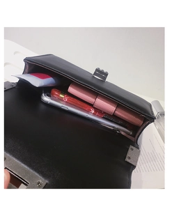 Interior view of black leather crossbody bag showing capacity for phone and wallet