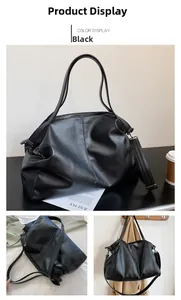 Detail of black large-capacity PU leather tote bag with lychee texture and shoulder strap