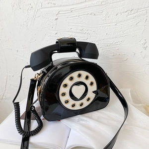 Creative retro phone handbag in black patent leather with vintage dial design and handset handle