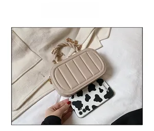 Detailed comparison of beige PU leather bag with phone showing compact box shape and size