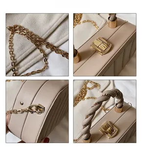 Close-up of beige quilted leather bag with golden twist lock and metallic chain detail