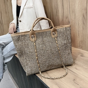 Brown tweed tote bag with leather handles and metal chain strap for women