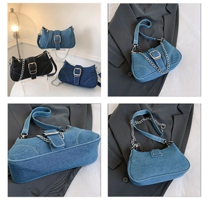 Detailed view of denim shoulder bag with silver buckle and contrast stitching accents