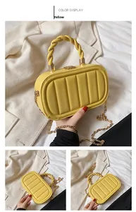 Detail view of yellow quilted leather crossbody bag with woven handle and gold chain strap