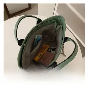 Interior view showing large capacity and multi-pocket storage of the striped tote bag