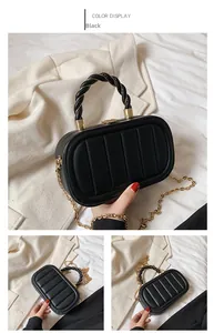 Detailed view of black oval quilted handbag with gold chain strap and rope handle