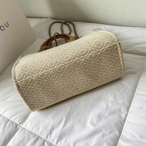 Ethnic style woven diamond pattern tote bag with leather handles and chain strap