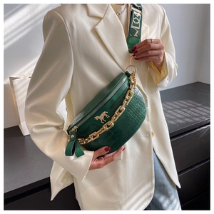 Detail of dark green croc-effect crossbody bag with gold chain and horse ornament