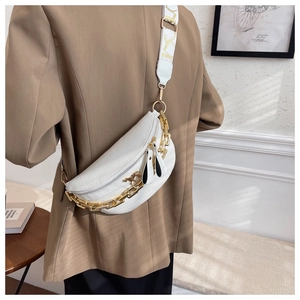 Detailed side view of white crocodile pattern crossbody bag with gold chain and horse buckle