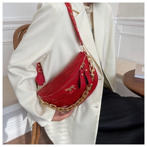 Red crescent bag with crocodile pattern and golden horse logo shown on white suit