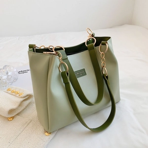 Detail of Morandi green tote bag with dark green handles and elegant gold chain accents