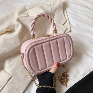 Chic pink quilted crossbody bag with a braided handle and stylish gold chain strap