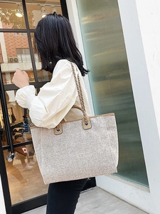 Chic shimmering bucket tote bag with chain strap and top handles for women