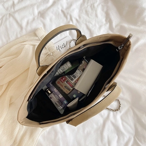 Large khaki tote bag with spacious interior compartments and multiple daily essentials