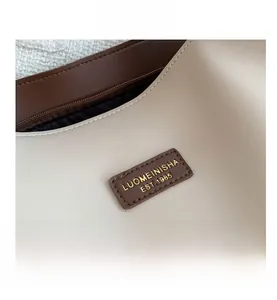 Detail of premium PU leather tote with brand logo tag and smooth metal zipper