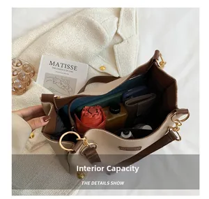 Spacious interior of beige and brown tote bag showing storage for daily essentials