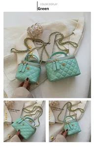 Detail of mint green quilted chain bucket bag with gold flower accent and double zippers
