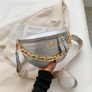 Silver crocodile textured saddle bag with gold chain and wide geometric strap