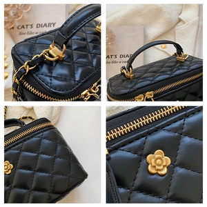 Close-up of diamond quilted leather, vintage gold zipper, and camellia metal badge