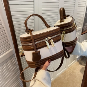 Retro cream and brown vanity box bag with gold hardware shown via mirror reflection