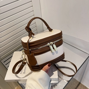 Minimalist square crossbody bag in brown and beige leather with top handle and strap