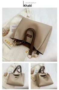 Detail of khaki leather tote with gold chain link straps and elegant side branding