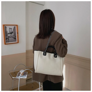 Detailed back view of a minimalist large capacity tote bag with silver chain straps