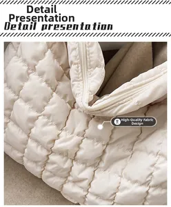 Close-up of white quilted down fabric with diamond pattern and smooth zipper detail