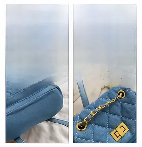 Close-up details of blue denim backpack with gold hardware and diamond quilted pattern
