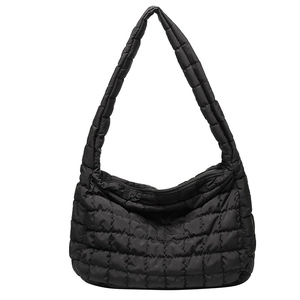 Black quilted puffer tote bag with a minimalist large capacity design and wide shoulder strap