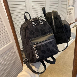 Mini zaino in tela jacquard nera con motivi floreali e cerniere a fiore argentate