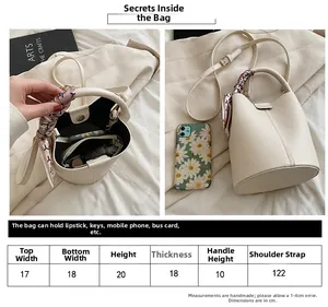Detailed size chart for beige bucket bag with ribbon handle and interior storage view