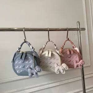 Three-color round crossbody bags with horse pattern and silk scarf handle detail
