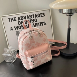 Mini zaino chic in jacquard floreale rosa con ciondolo a forma di fiore sulla cerniera