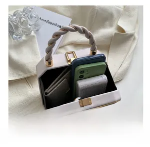 White structured handbag interior showing space for phone, wallet and power bank