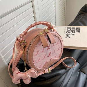 Pink round leather crossbody bag with horse print pattern and decorative silk scarf handle