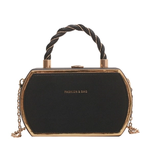 Chic black hexagonal leather handbag with gold frame and chain strap in a white background