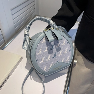 Light blue round crossbody bag with animal patterns and silk scarf wrapped handle